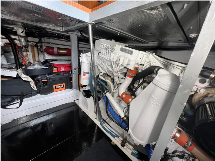 Kemo Sabe Yacht Photos Pics Engine room of a 1981 Bertram 45 Convertible boat, showcasing mechanical components and storage.