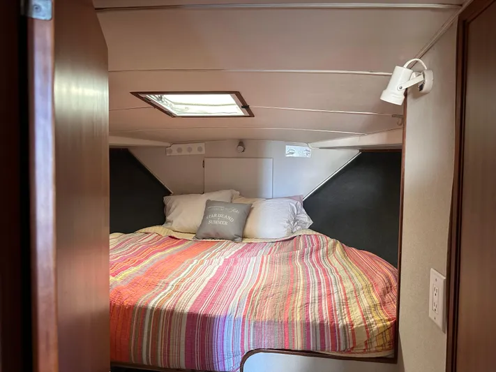 Kemo Sabe Yacht Photos Pics Cozy bedroom in 1981 Bertram 45 Convertible yacht with colorful striped bedding.
