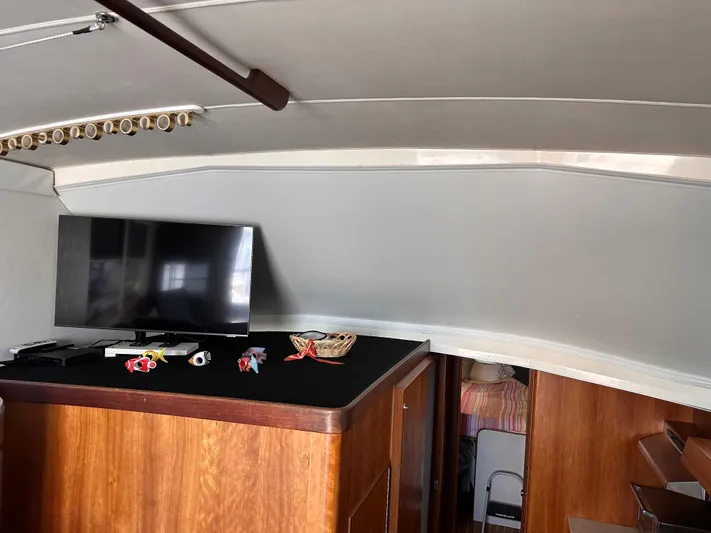 Kemo Sabe Yacht Photos Pics Interior of 1981 Bertram 45 Convertible yacht with TV and wooden cabinetry.