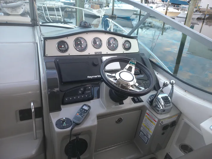 Stella Nautica Yacht Photos Pics 2015 Sea Ray 330 Sundancer helm with steering wheel and control panel at marina.