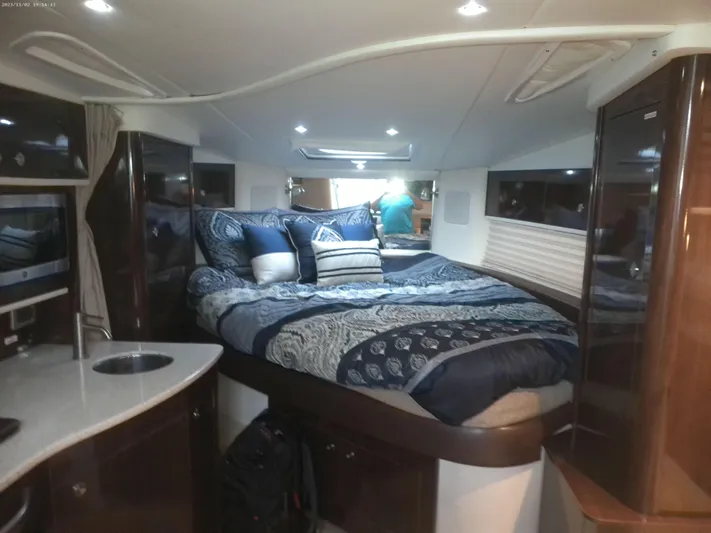 Stella Nautica Yacht Photos Pics Luxurious interior of 2015 Sea Ray 330 Sundancer with cozy bed and modern amenities.