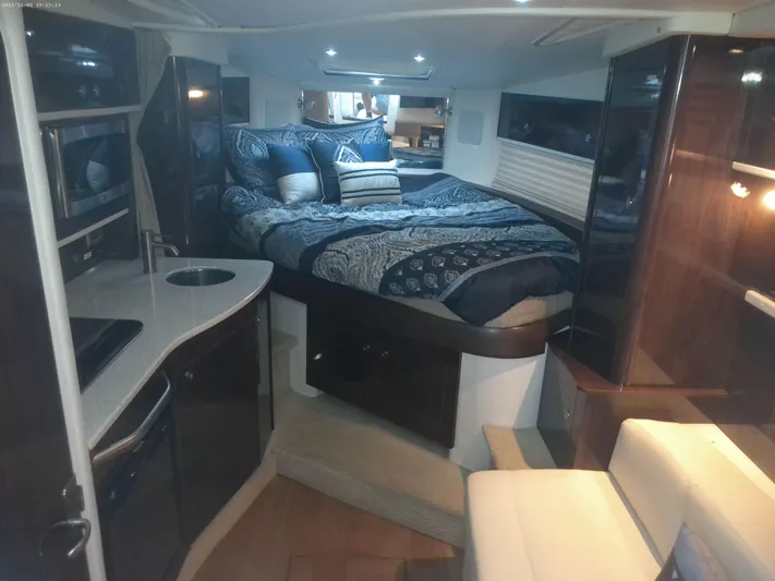 Stella Nautica Yacht Photos Pics Luxurious interior of 2015 Sea Ray 330 Sundancer yacht with cozy bed and kitchenette.