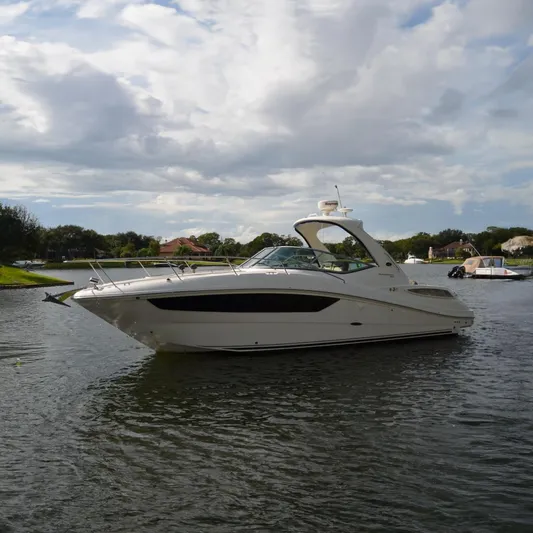 Stella Nautica Yacht Photos Pics 2015 Sea Ray 330 Sundancer yacht on a calm lake under cloudy skies.