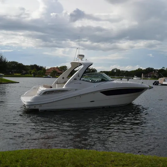 Stella Nautica Yacht Photos Pics 2015 Sea Ray 330 Sundancer boat on a calm lake under cloudy skies.
