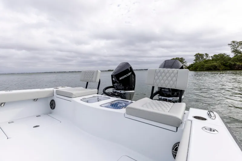  Yacht Photos Pics 2024 Freeman 28 boat with Mercury engines on a calm lake.