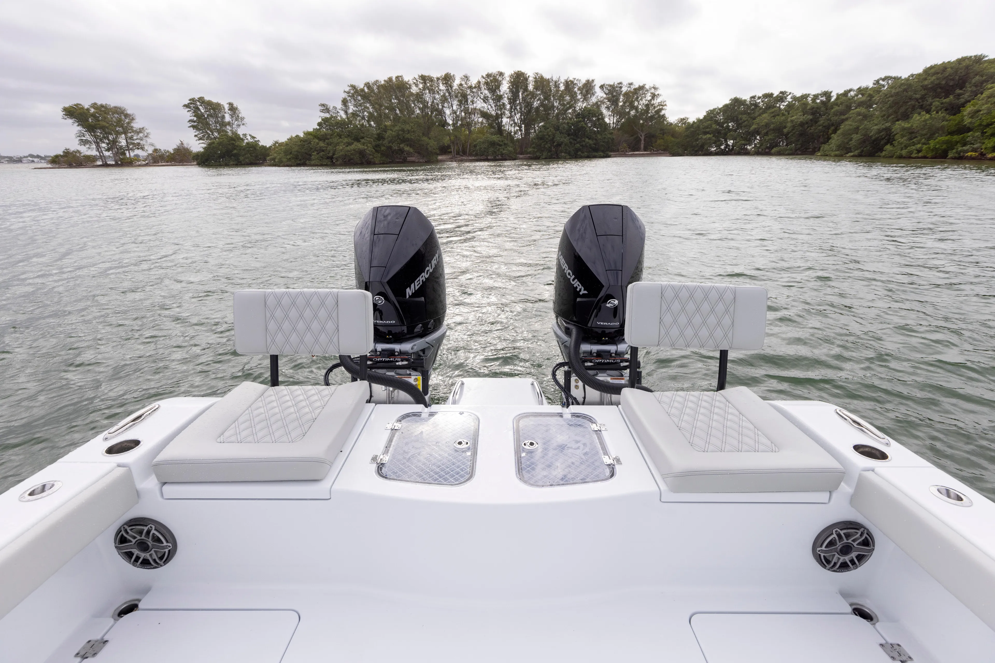  Yacht Photos Pics 2024 Freeman 28 boat with twin outboard engines on a calm lake.