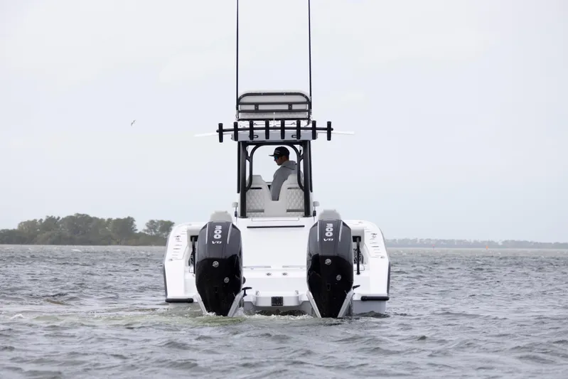  Yacht Photos Pics 2024 Freeman 28 boat with dual outboard engines on the water.