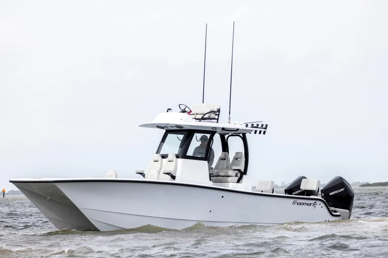  Yacht Photos Pics 2024 Freeman 28 boat with twin outboard motors on the water.