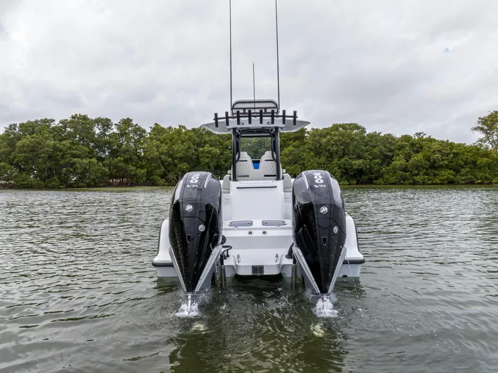  Yacht Photos Pics 2024 Freeman 28 boat with dual outboard engines on the water.