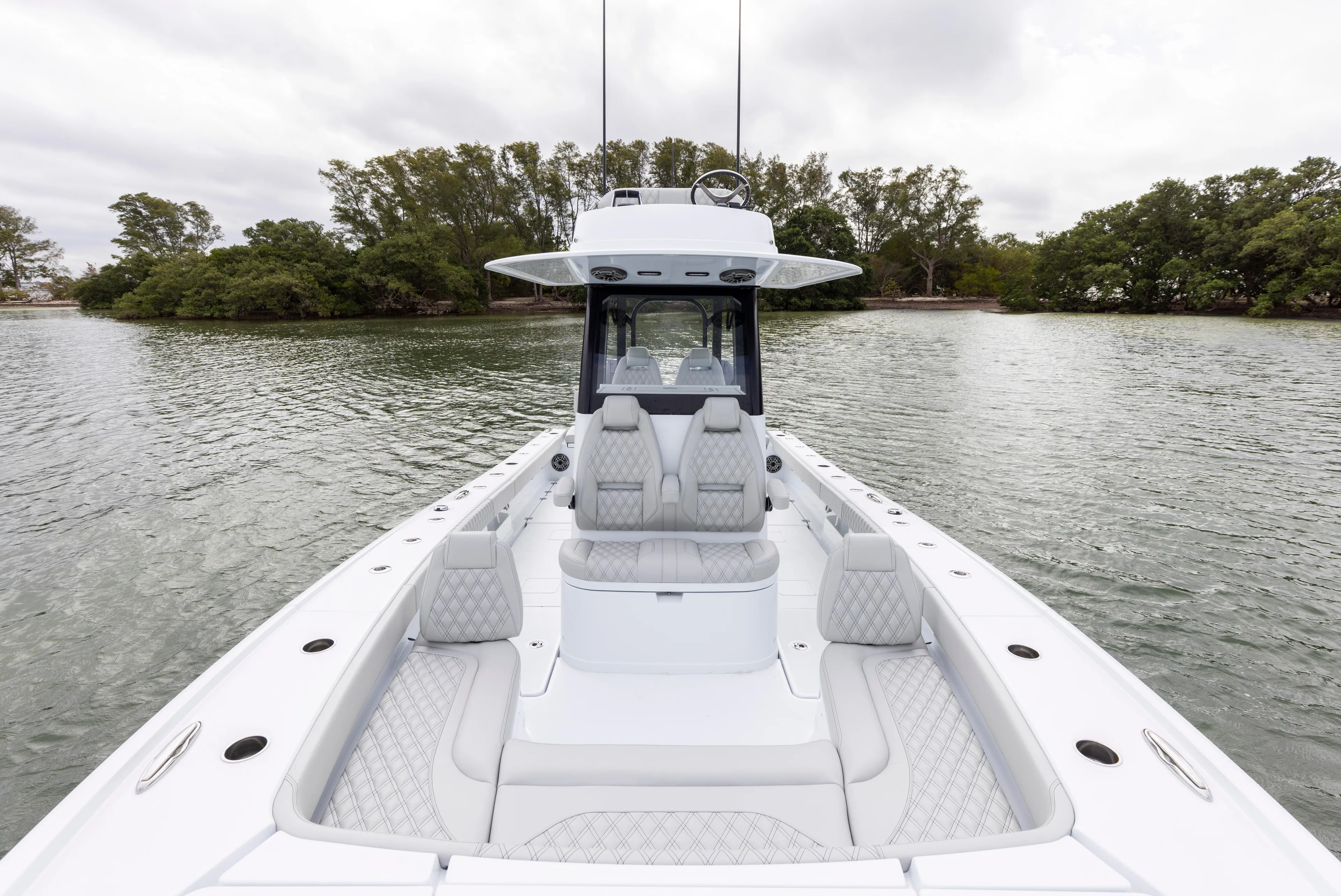  Yacht Photos Pics 2024 Freeman 28 boat with luxurious seating on calm water.