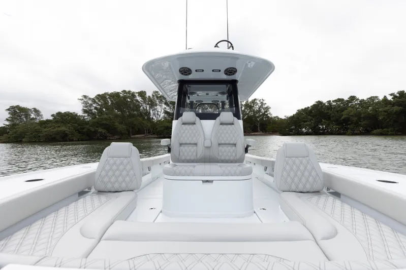  Yacht Photos Pics 2024 Freeman 28 boat with luxurious seating on a calm lake.