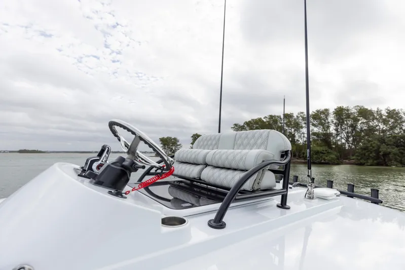  Yacht Photos Pics 2024 Freeman 28 boat helm with cushioned seating and steering wheel.