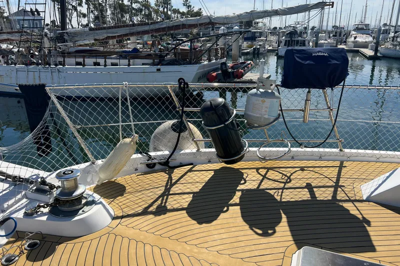 Kailani Yacht Photos Pics Deck of 1991 Viking 63 Motor Yacht with marina view, featuring equipment and safety netting.