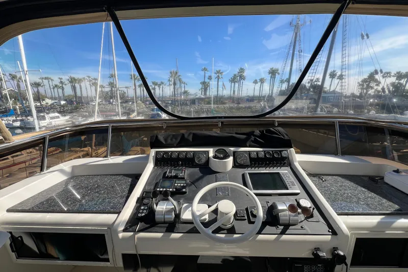 Kailani Yacht Photos Pics Cockpit view of 1991 Viking 63 Motor Yacht with marina backdrop.