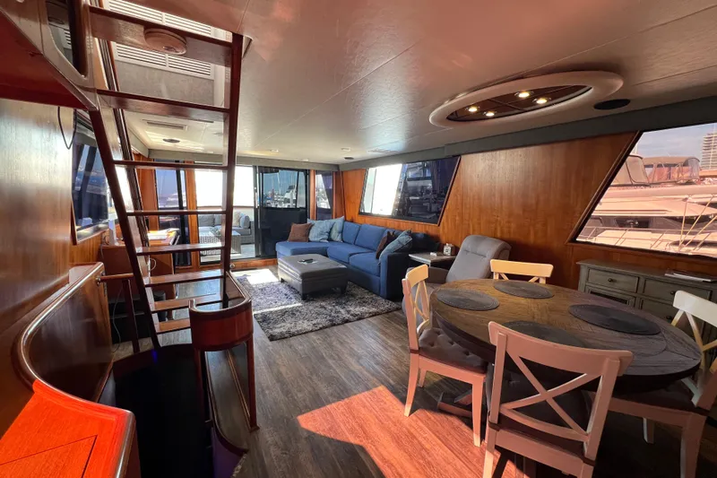 Kailani Yacht Photos Pics Luxurious interior of a 1991 Viking 63 Motor Yacht with modern furnishings and wood accents.