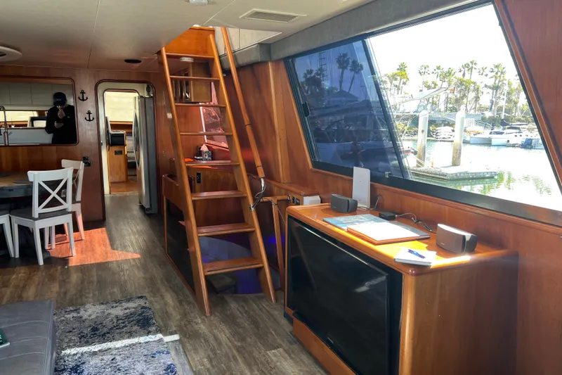Kailani Yacht Photos Pics Interior of 1991 Viking 63 Motor Yacht with wooden decor and marina view.