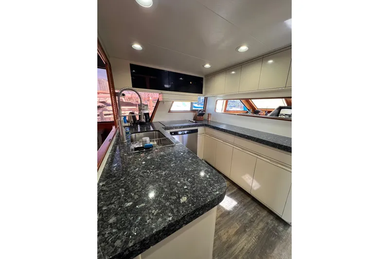 Kailani Yacht Photos Pics Luxurious kitchen interior of 1991 Viking 63 Motor Yacht with granite countertops.
