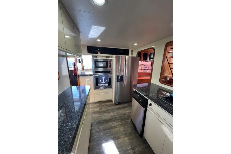Kailani Yacht Photos Pics Modern kitchen interior of 1991 Viking 63 Motor Yacht with stainless steel appliances.
