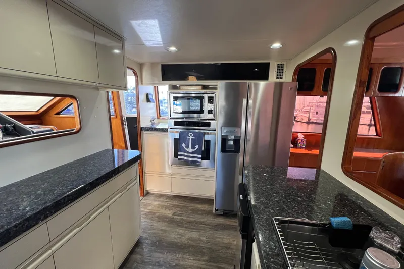 Kailani Yacht Photos Pics Luxurious kitchen interior of 1991 Viking 63 Motor Yacht with modern appliances.