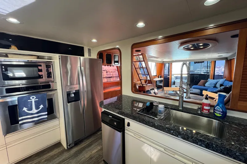 Kailani Yacht Photos Pics Luxurious kitchen interior of a 1991 Viking 63 Motor Yacht with modern appliances.
