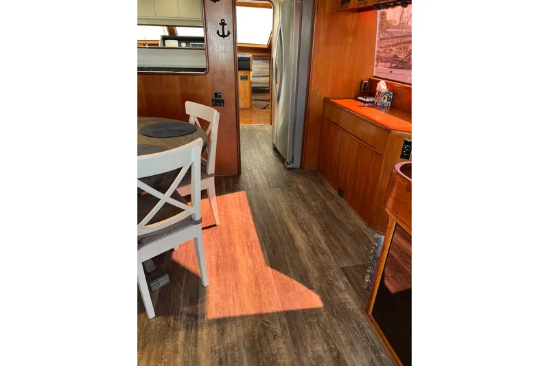 Kailani Yacht Photos Pics View of wood flooring and dining area towards galley.