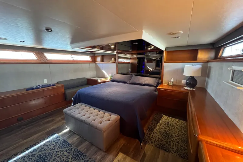 Kailani Yacht Photos Pics Master stateroom with walkaround King bed wit elegant wood finishes.