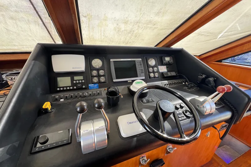 Kailani Yacht Photos Pics Lower helm in Pilothouse with steering wheel and navigation instruments.
