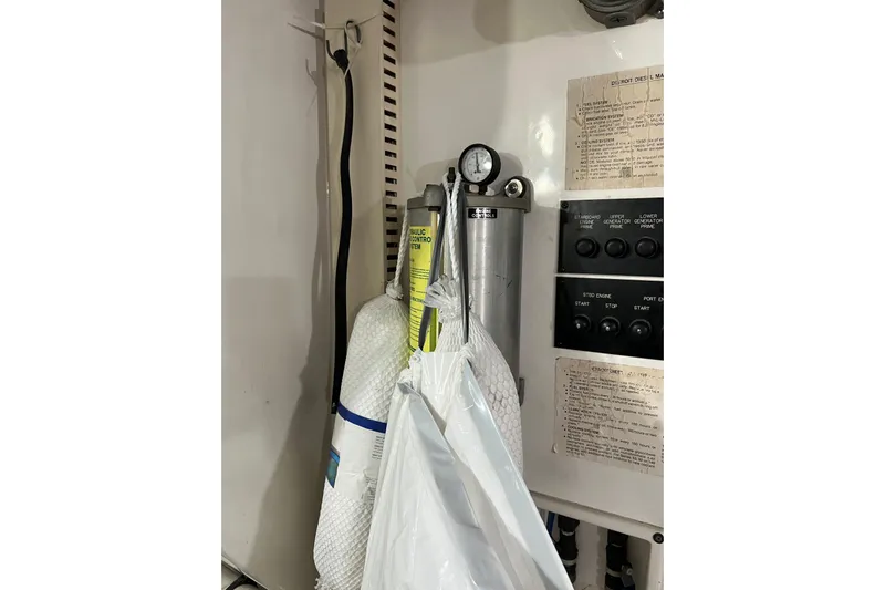 Kailani Yacht Photos Pics aft engine room wall with throttle controls and hydrolic cylinders