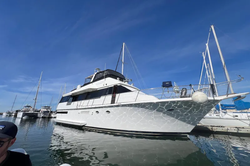 Kailani Yacht Photos Pics 1991 Viking 63 Motor Yacht docked in marina under clear blue sky.