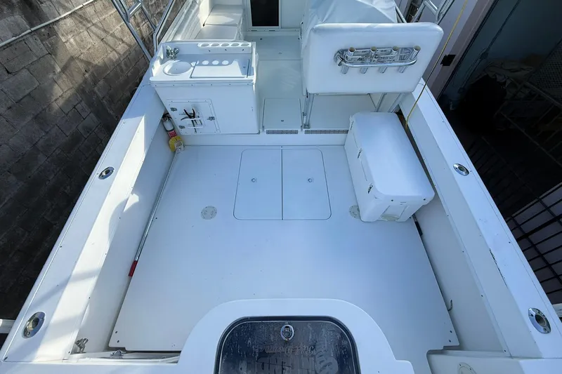 Reel Dreamz Yacht Photos Pics 1998 Contender 35 Express boat deck with storage, sink, and seating area.