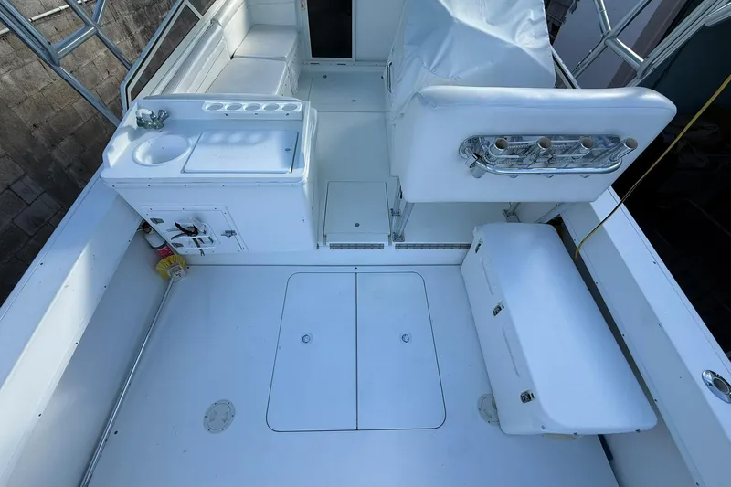 Reel Dreamz Yacht Photos Pics 1998 Contender 35 Express boat interior with seating, sink, and storage compartments.