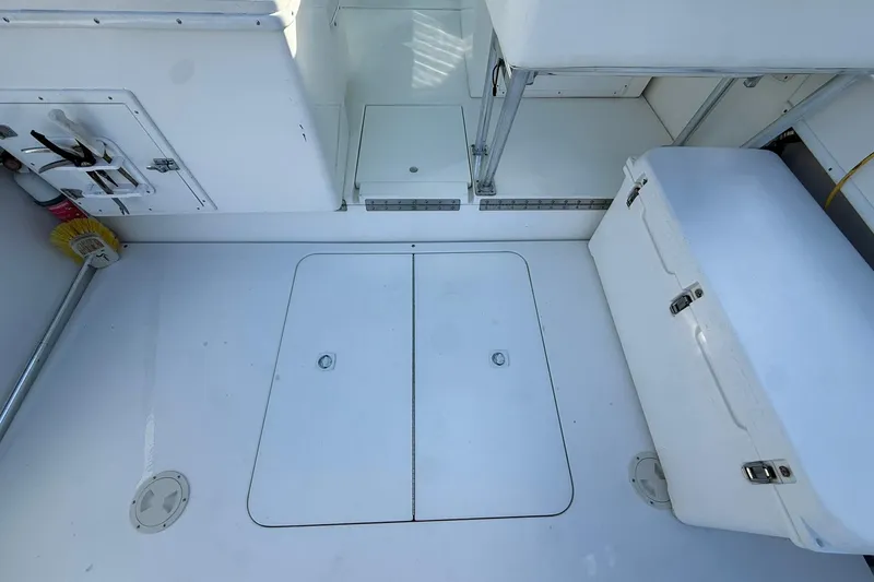 Reel Dreamz Yacht Photos Pics 1998 Contender 35 Express boat deck with storage compartments and cooler.