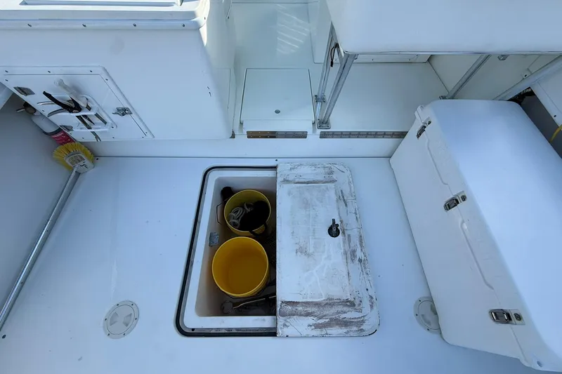 Reel Dreamz Yacht Photos Pics 1998 Contender 35 Express boat deck with storage compartments and cleaning supplies.