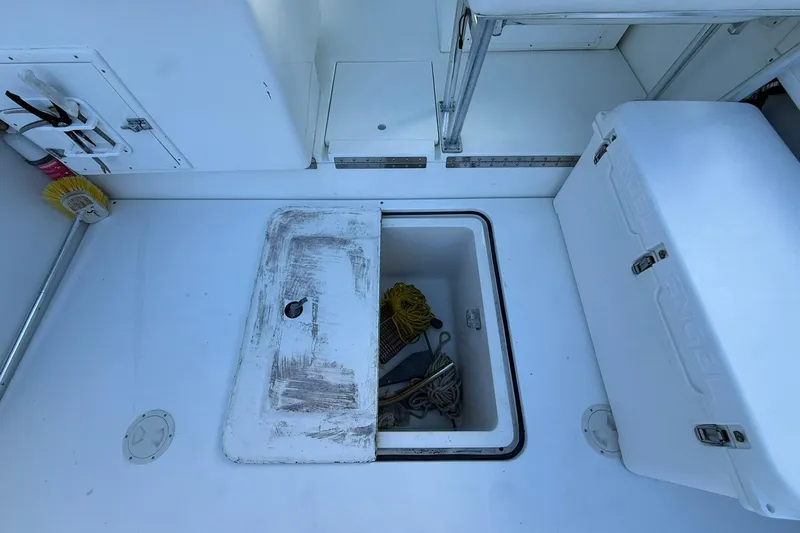 Reel Dreamz Yacht Photos Pics 1998 Contender 35 Express boat deck with storage compartment and cooler.