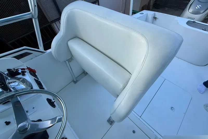 Reel Dreamz Yacht Photos Pics 1998 Contender 35 Express boat interior with white cushioned seating and steering wheel.