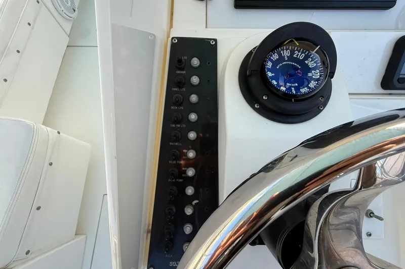 Reel Dreamz Yacht Photos Pics 1998 Contender 35 Express boat dashboard with compass and control panel.