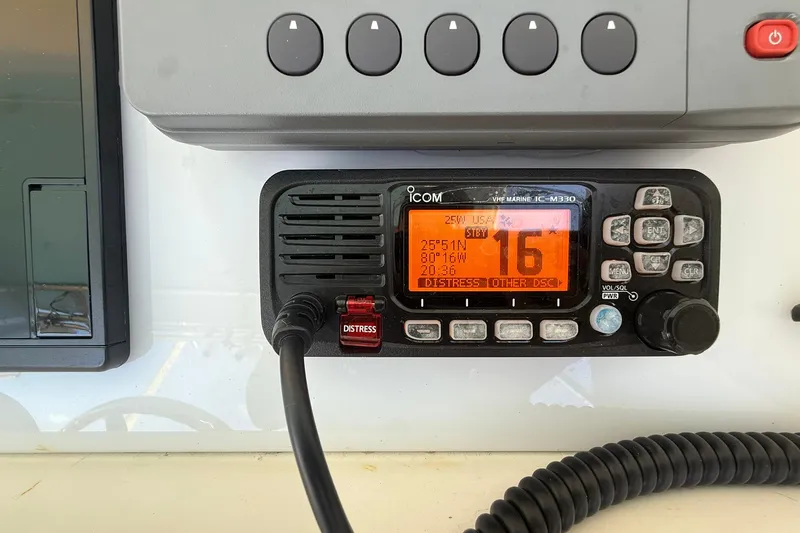 Reel Dreamz Yacht Photos Pics VHF marine radio on 1998 Contender 35 Express boat, displaying channel 16 and coordinates.