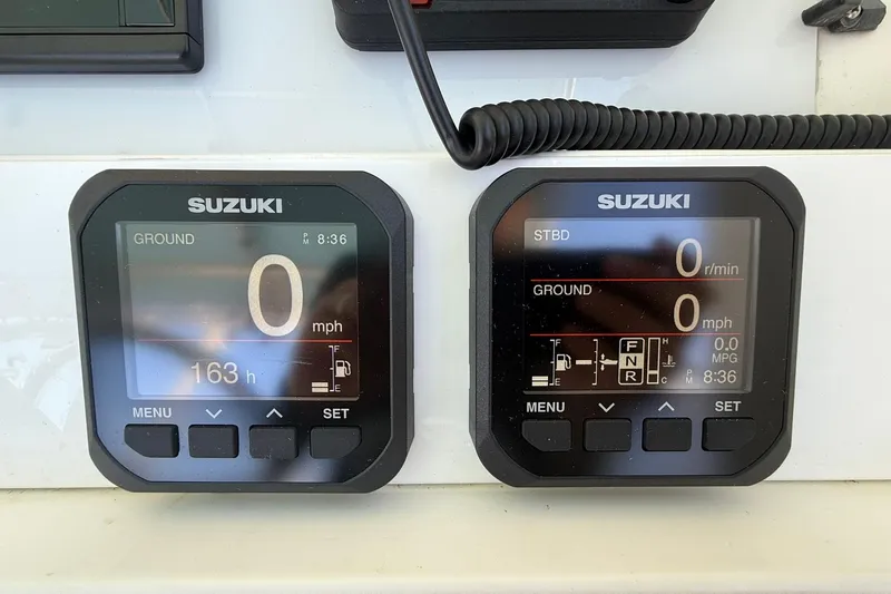 Reel Dreamz Yacht Photos Pics Suzuki digital gauges on a 1998 Contender 35 Express boat dashboard.