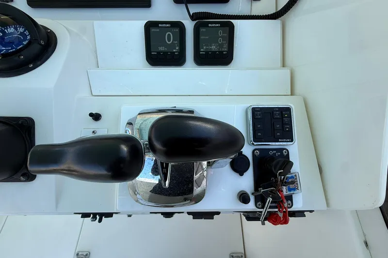 Reel Dreamz Yacht Photos Pics Control panel of a 1998 Contender 35 Express boat with Suzuki instruments.