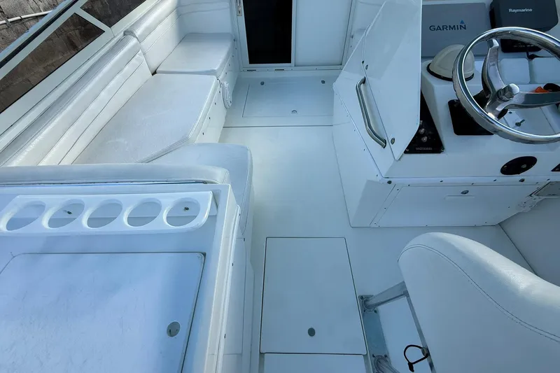 Reel Dreamz Yacht Photos Pics 1998 Contender 35 Express boat interior with white seating and steering console.