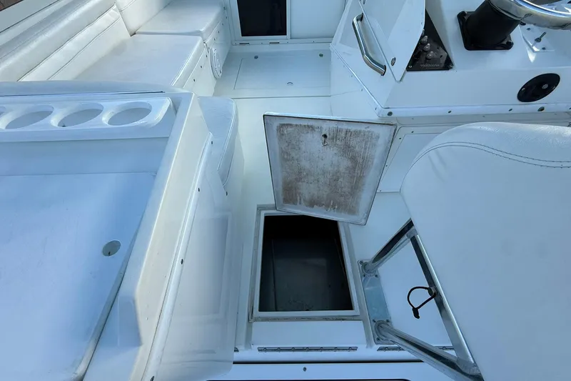 Reel Dreamz Yacht Photos Pics 1998 Contender 35 Express boat interior with open storage compartment and seating area.