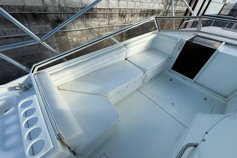 Reel Dreamz Yacht Photos Pics 1998 Contender 35 Express boat interior with white seating and storage compartments.