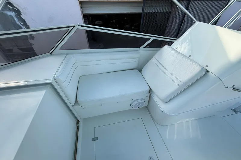 Reel Dreamz Yacht Photos Pics 1998 Contender 35 Express boat interior with white seating and storage compartment.