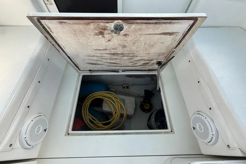Reel Dreamz Yacht Photos Pics Open storage compartment on a 1998 Contender 35 Express boat, showing equipment and accessories.