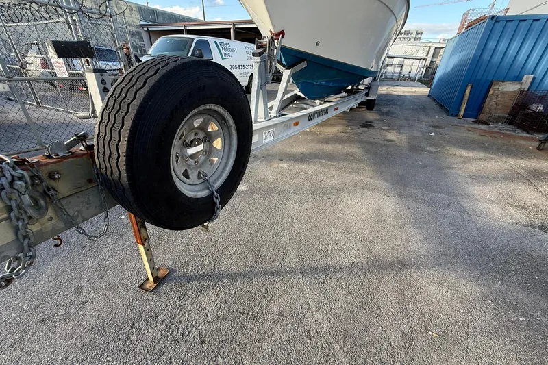 Reel Dreamz Yacht Photos Pics Trailer with 1998 Contender 35 Express boat in industrial yard setting.