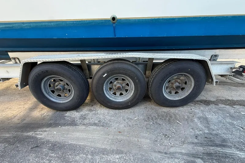 Reel Dreamz Yacht Photos Pics Triple-axle trailer for 1998 Contender 35 Express boat, side view.