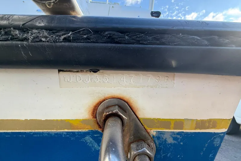 Reel Dreamz Yacht Photos Pics 1998 Contender 35 Express boat hull with visible serial number and metal fitting.