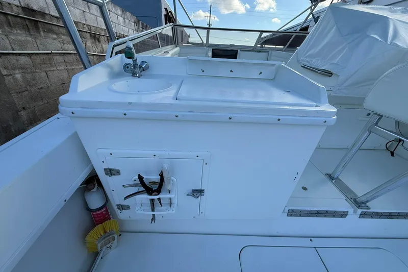 Reel Dreamz Yacht Photos Pics 1998 Contender 35 Express boat interior with sink and storage area.