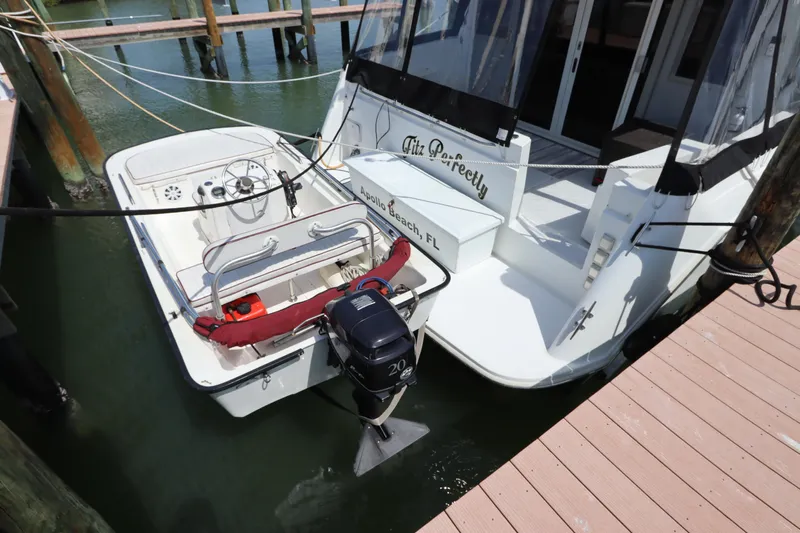 Fitz Perfectly Yacht Photos Pics 2001 Navigator 4800 CLASSIC yacht docked with attached motorboat in a marina.