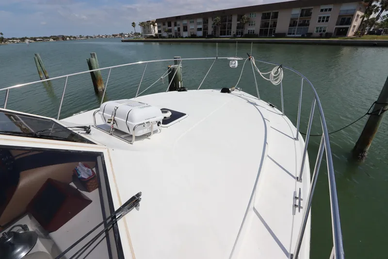Fitz Perfectly Yacht Photos Pics 2001 Navigator 4800 CLASSIC yacht docked in a serene waterfront setting.